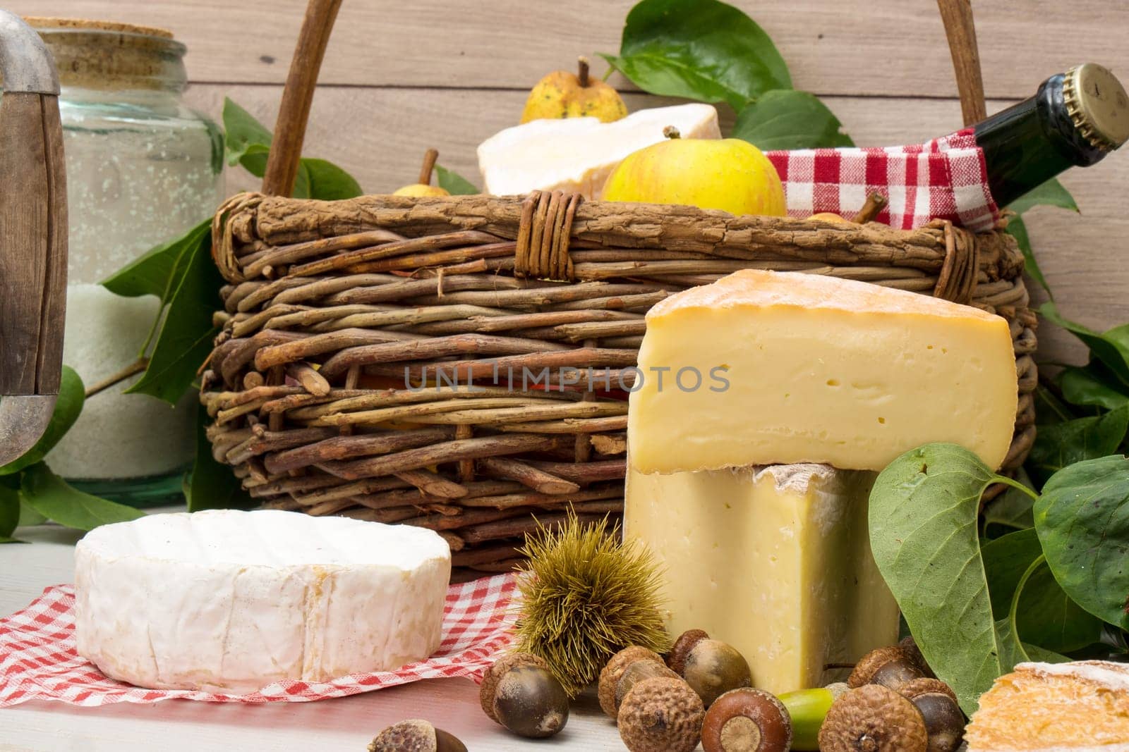 the french cheeses with a basket of apples