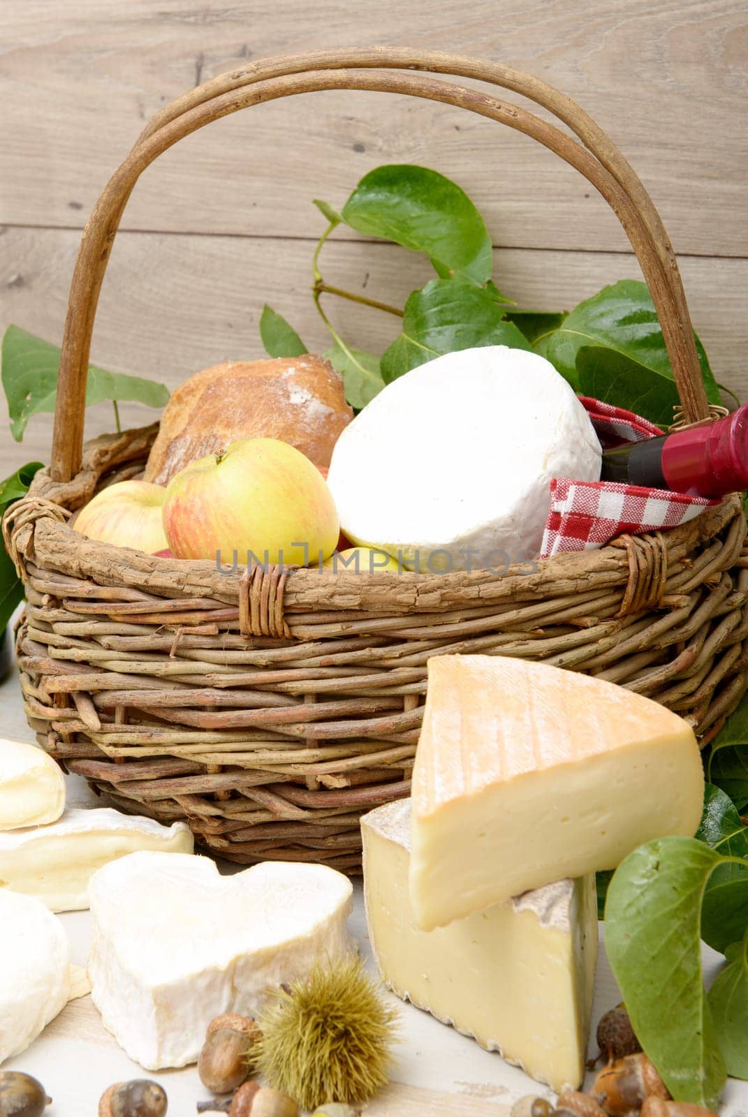 the french cheeses with a basket of apples