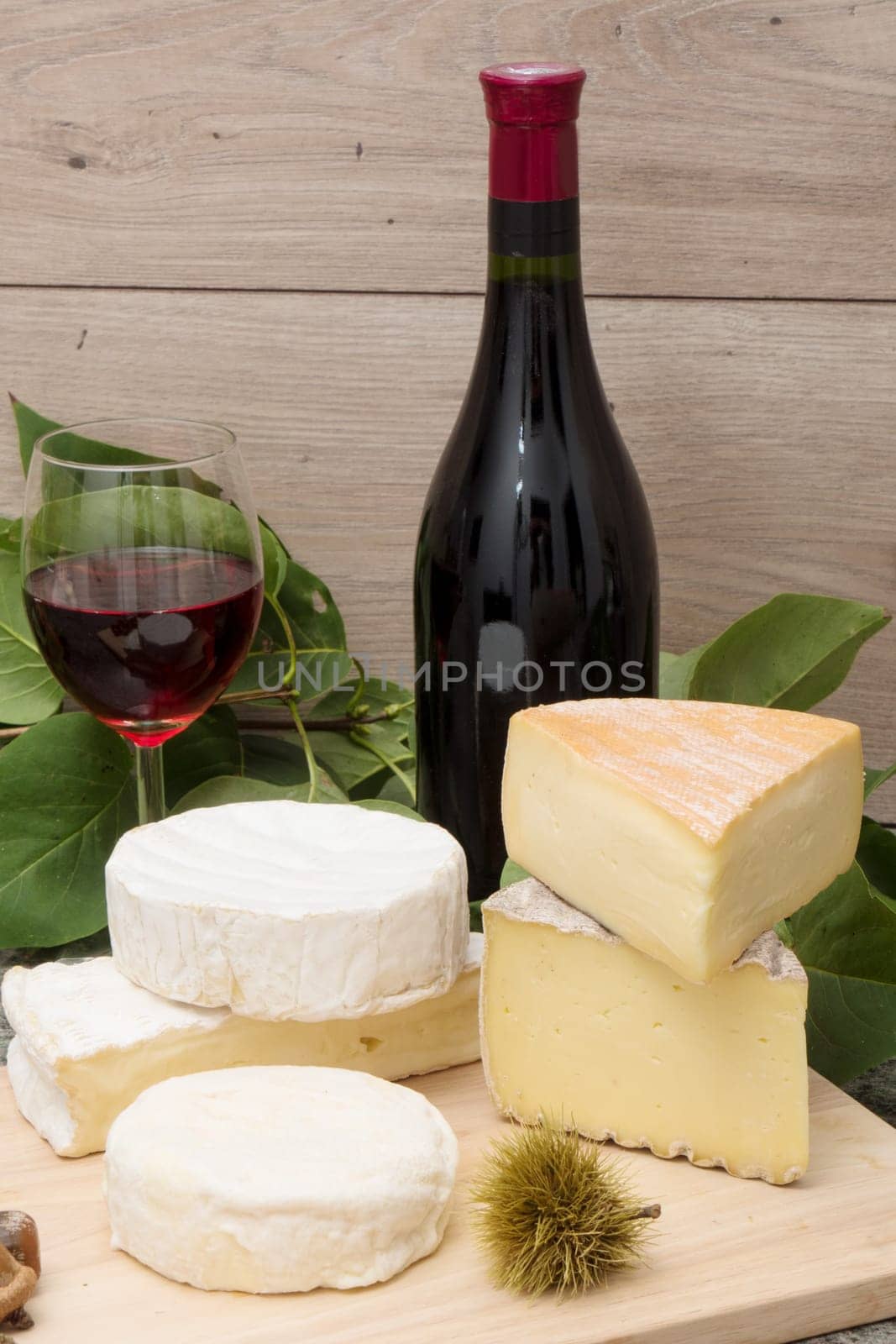 the french cheese with a glass and a bottle of wine