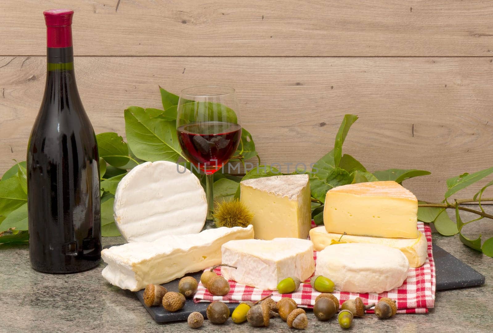 the french cheese with a glass and a bottle of wine