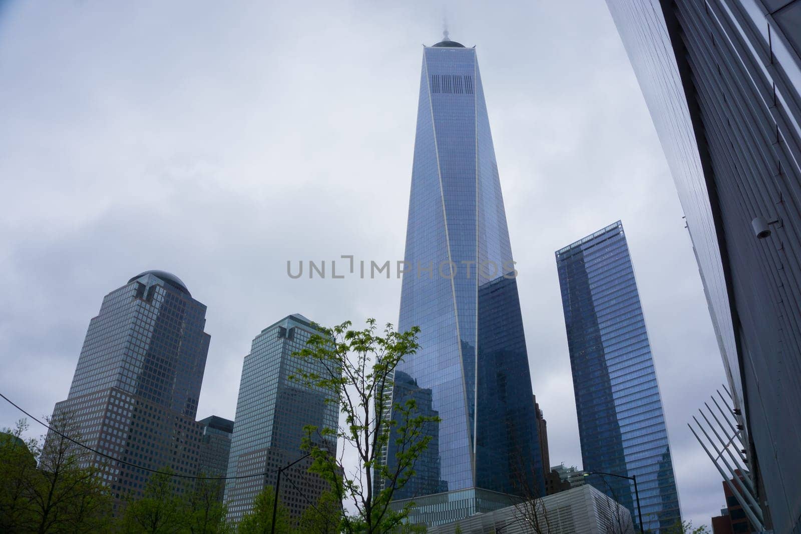 New York City, United States of America - May 01,2016: The almost finished One World Trade Center and memorial site in New York with blue sky on June 23, 2013
