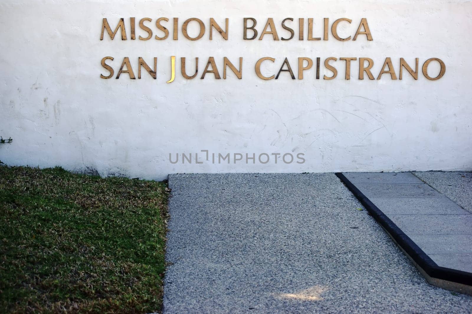 San Juan Capistrano,United States - December 25,2015: The gold-decorated nameplate of the Mission Basilica of San Juan Capistrano on a white wall on December 25,2015 in San Juan Capistrano.