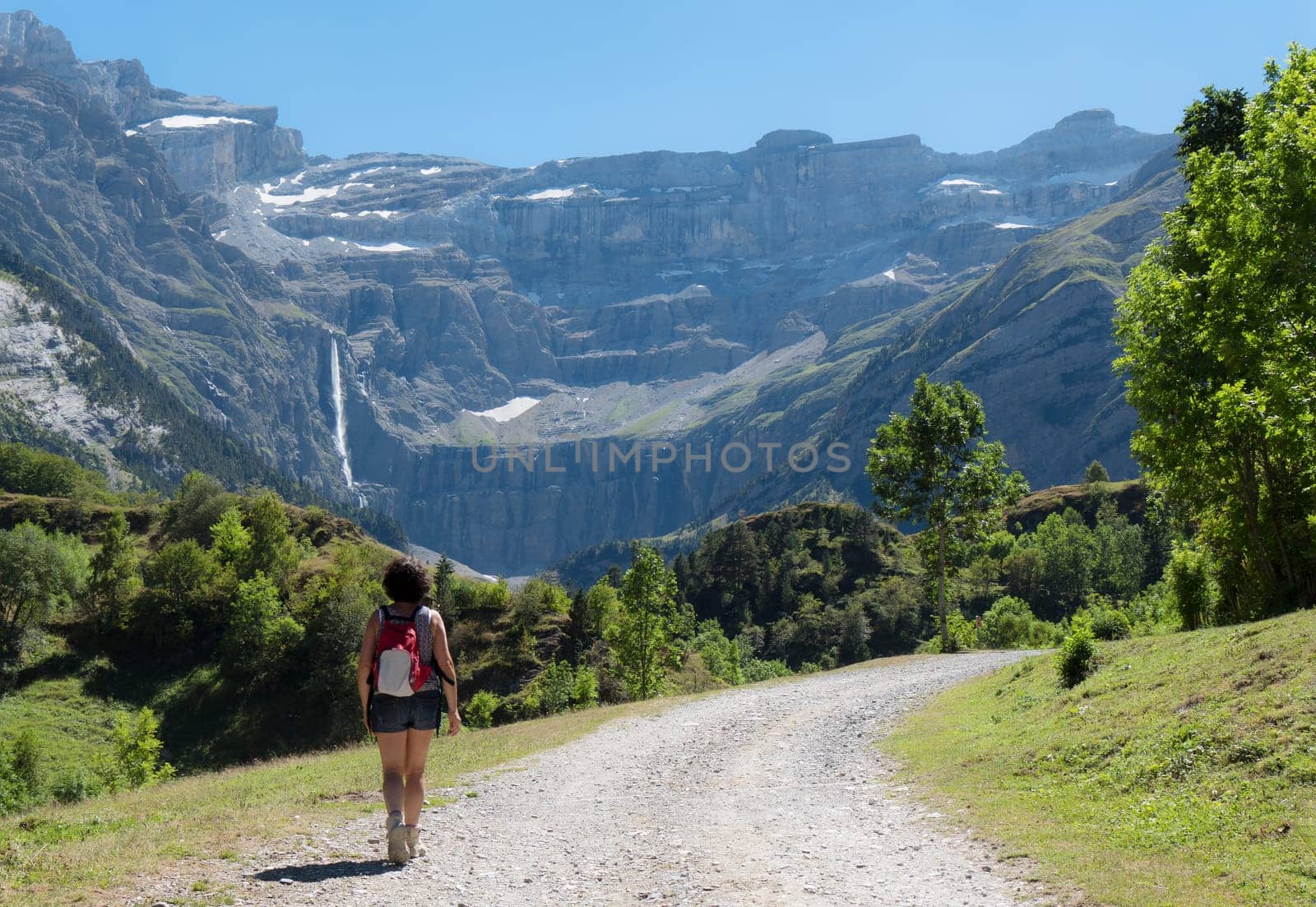 A woman hiker and cirque de Gavarnie in the French pyrenees