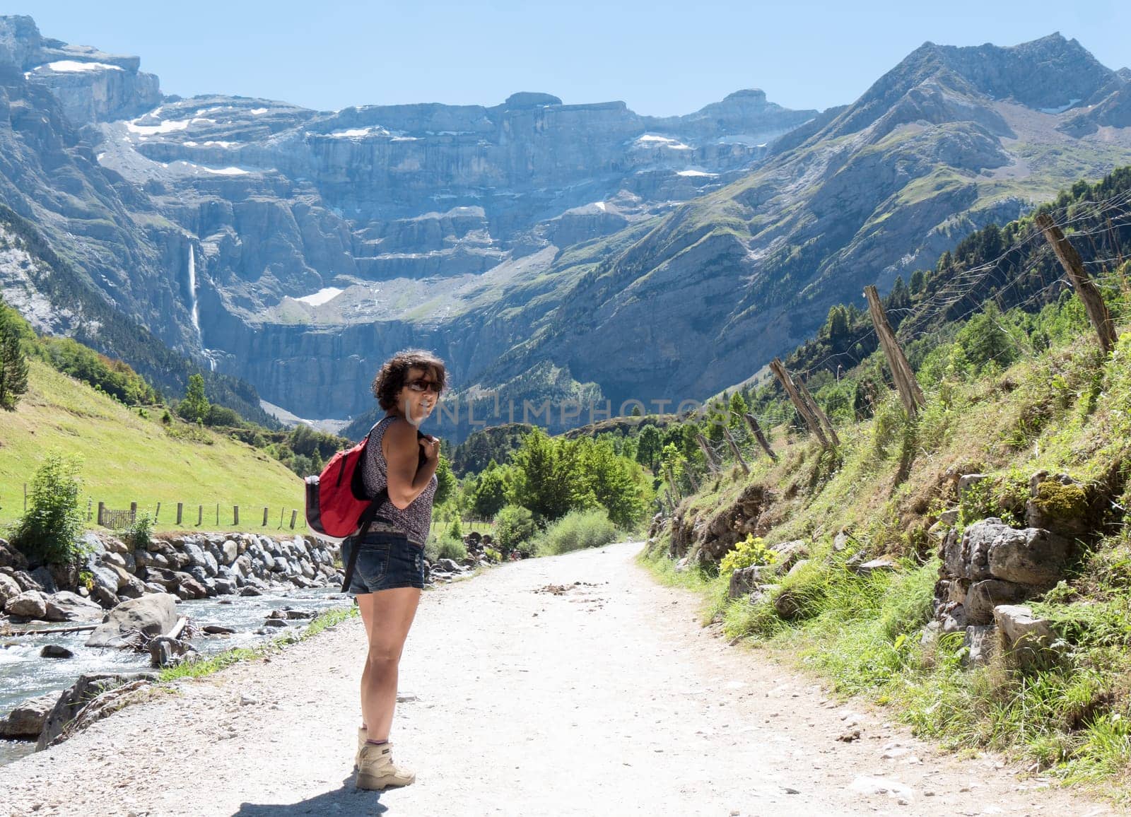 A woman hiker and cirque de Gavarnie in the French pyrenees