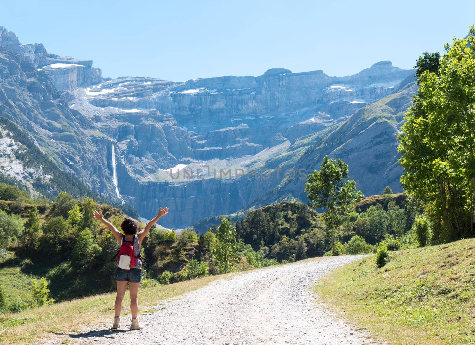 A woman hiker and cirque de Gavarnie in the French pyrenees