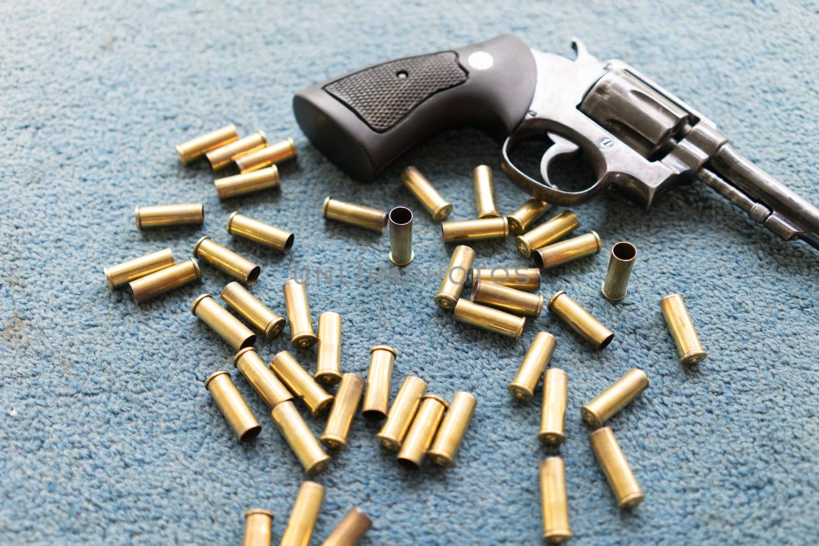 old revolver gun with many bullet shell