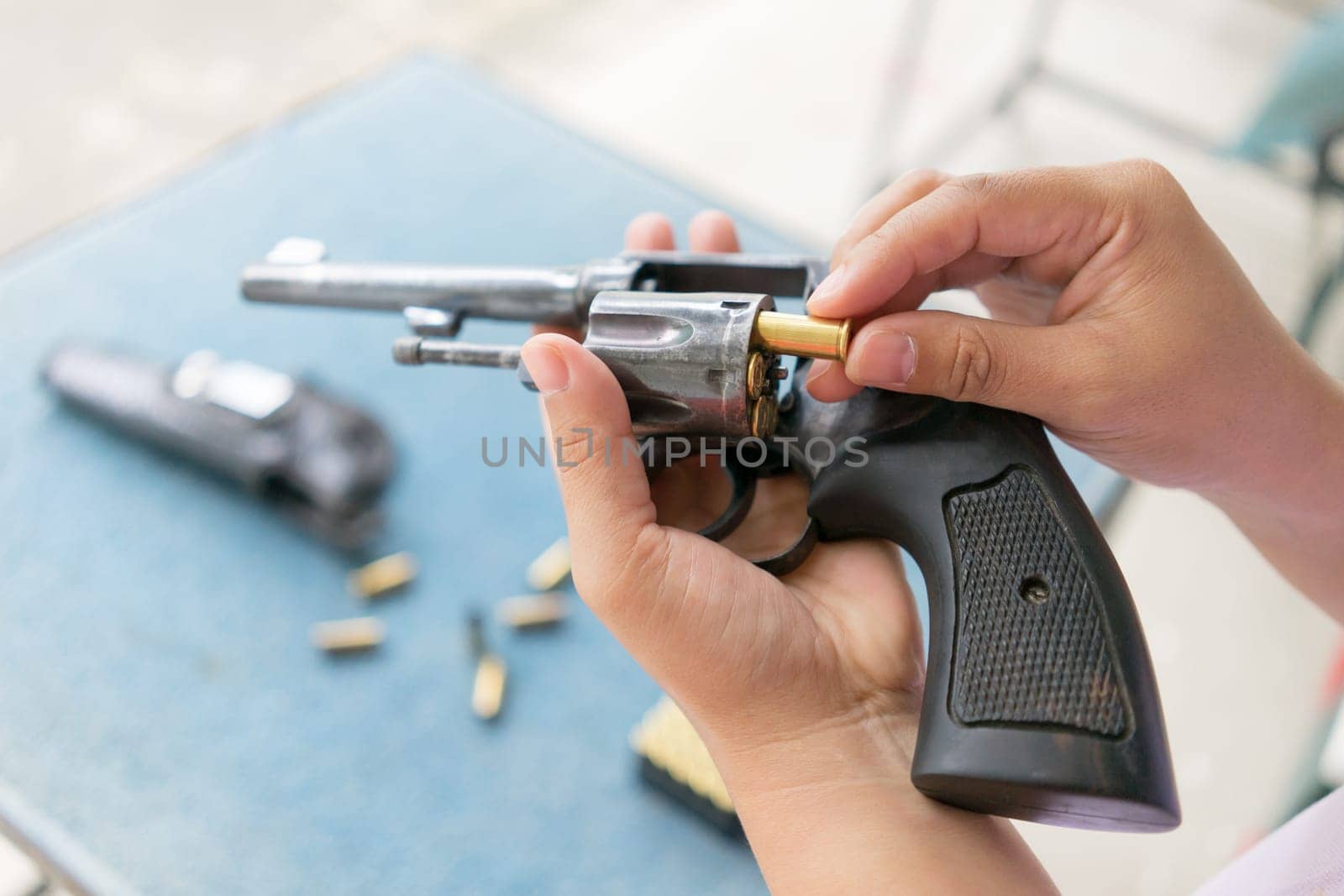 people load bullets into revolver gun befor shooting