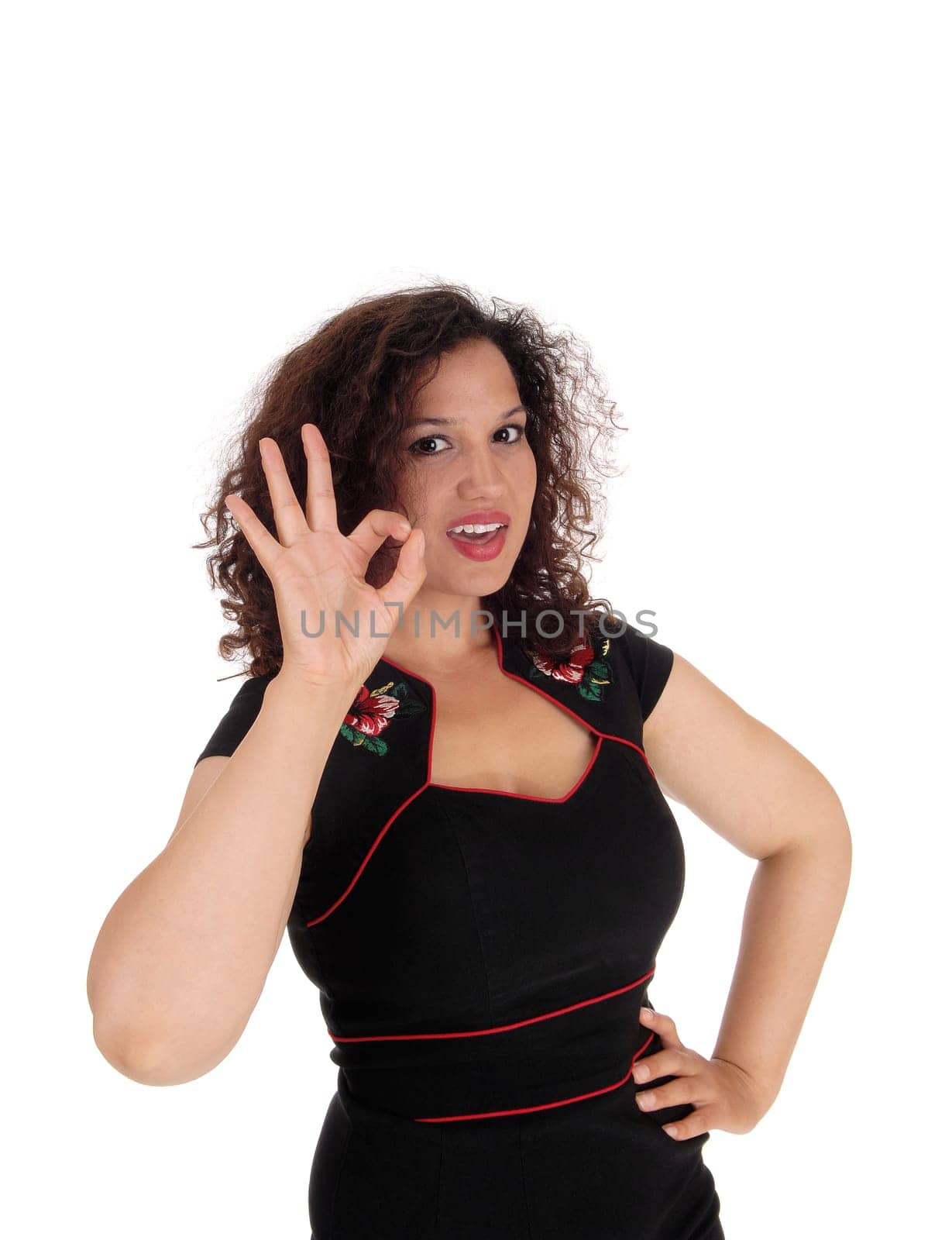 A happy young woman in a black dress signals with her hand it is perfect.in closeup, isolated for white background..