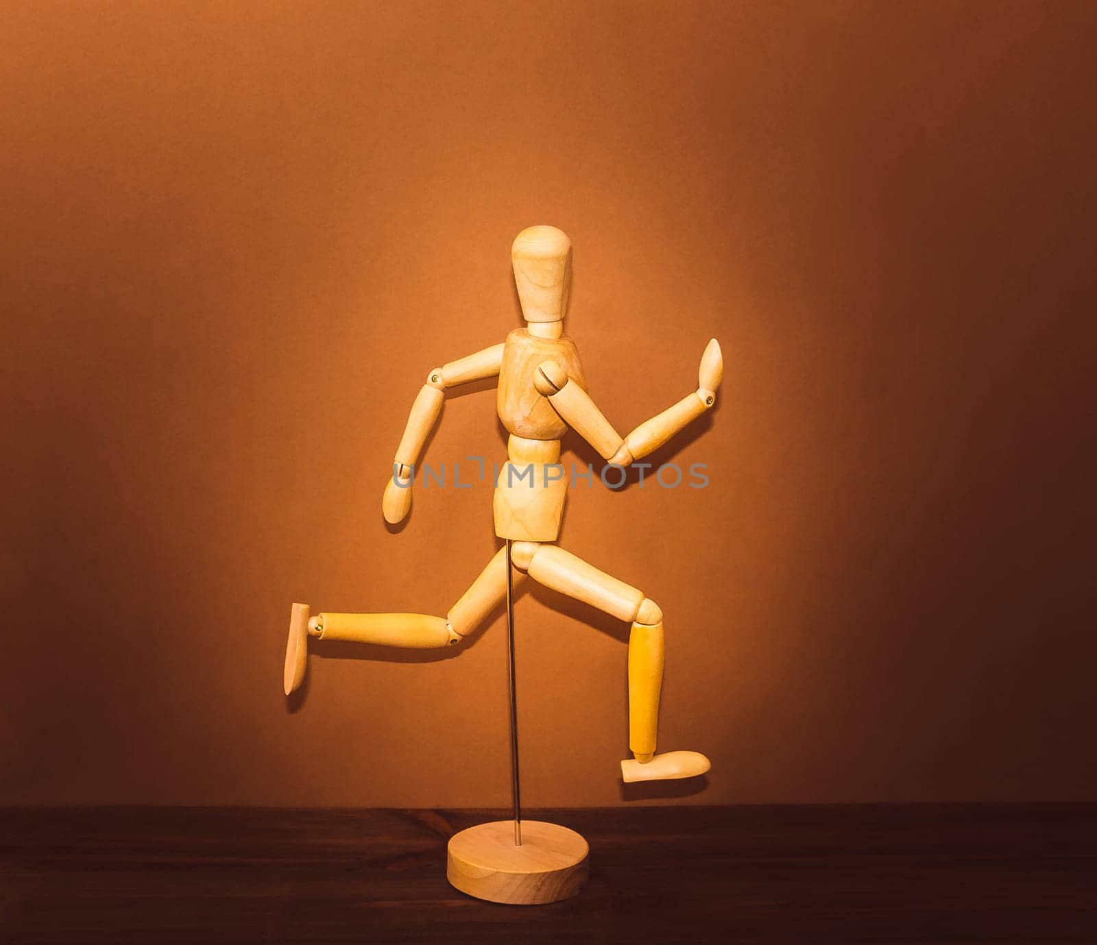 The figure of wooden man, running on wooden background