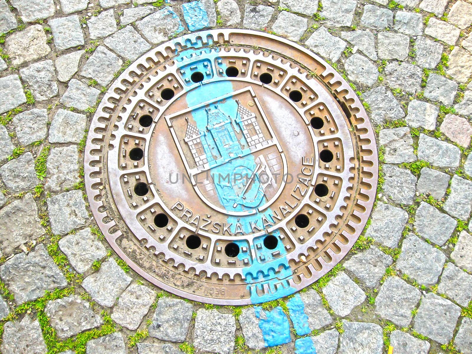 Manhole on old style brick road in Prague, Czech Republic