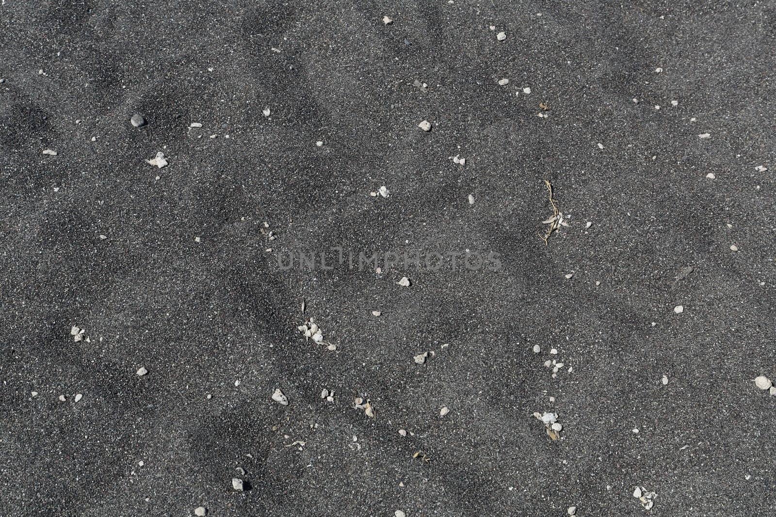 The Kamari beach with black volcanic stones at Santorini island, Greece