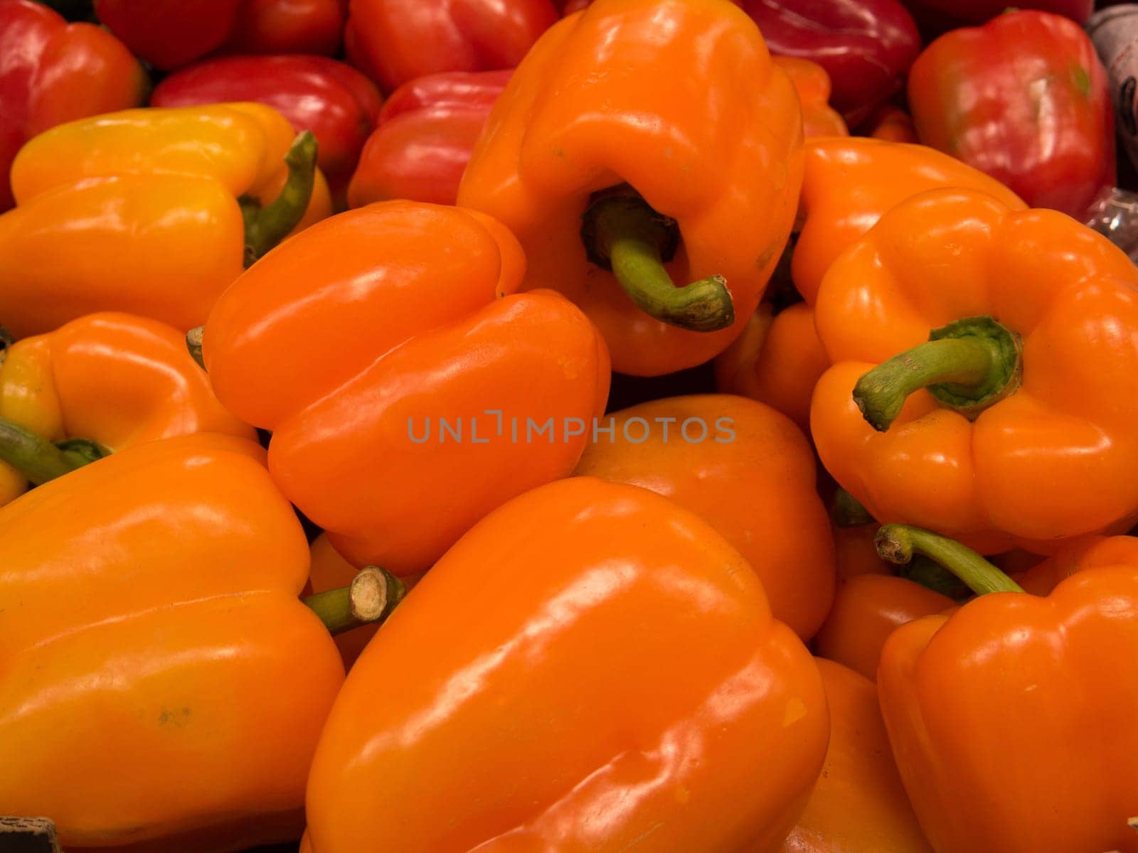 many orange pepper ready to sale on a big market