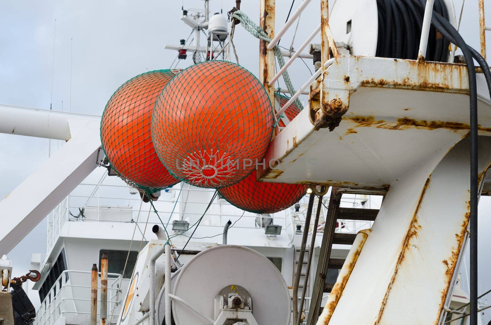 three big float on big fishingboat mark where the net is in the sea