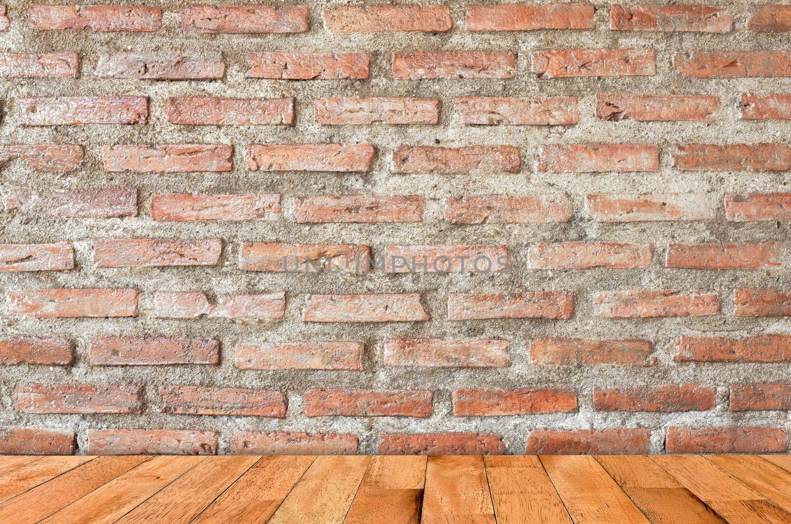 empty room with red brick wall and wooden floor