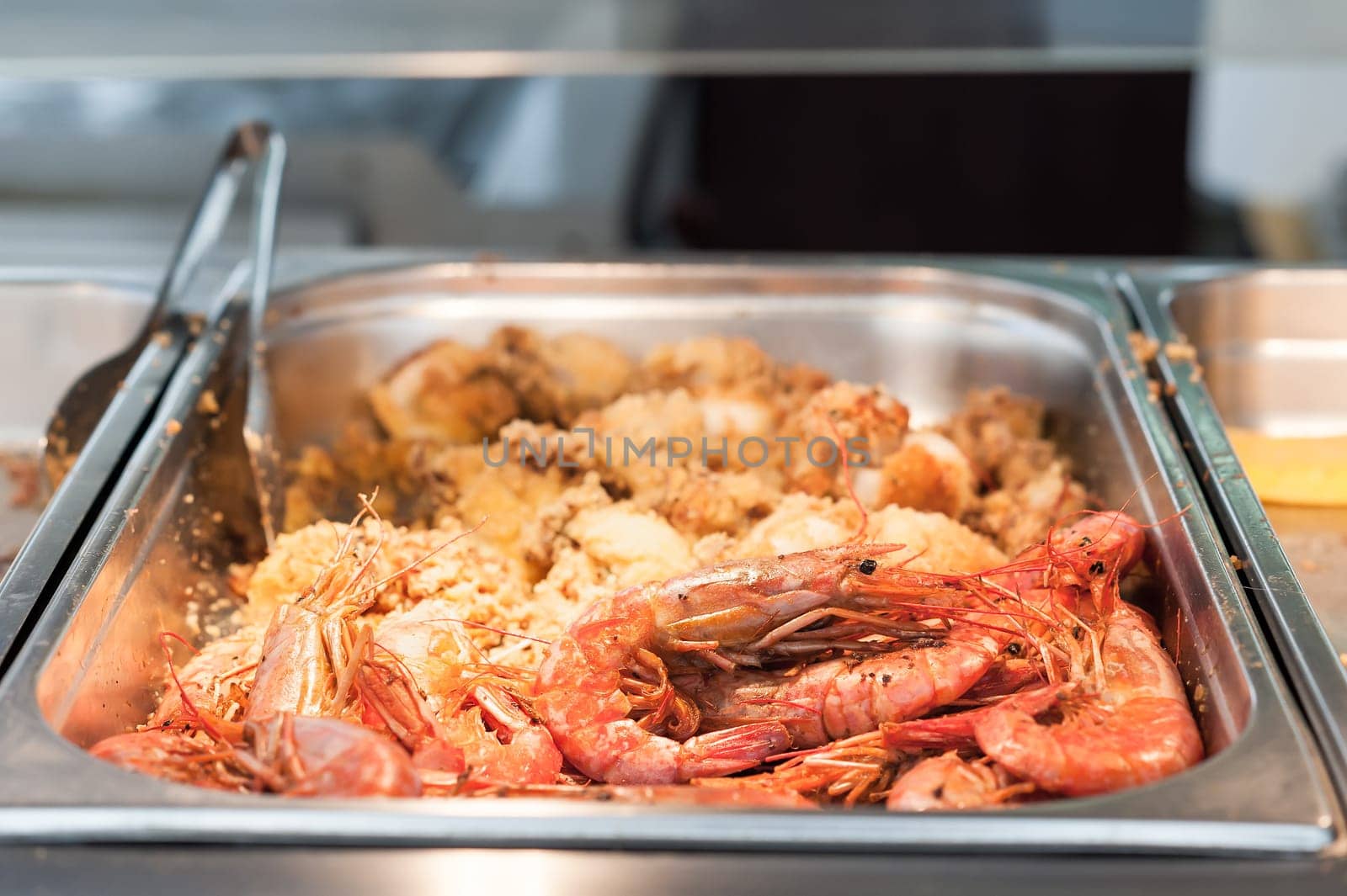 Close up of fried shrimp. In a pan of steel of a canteen.