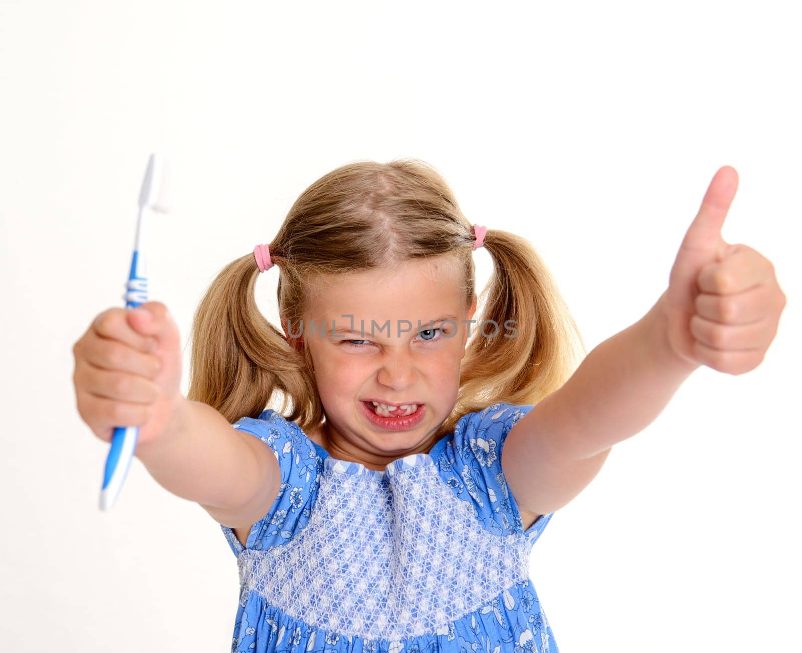 little funny girl with space width , thumb up and toothbrush