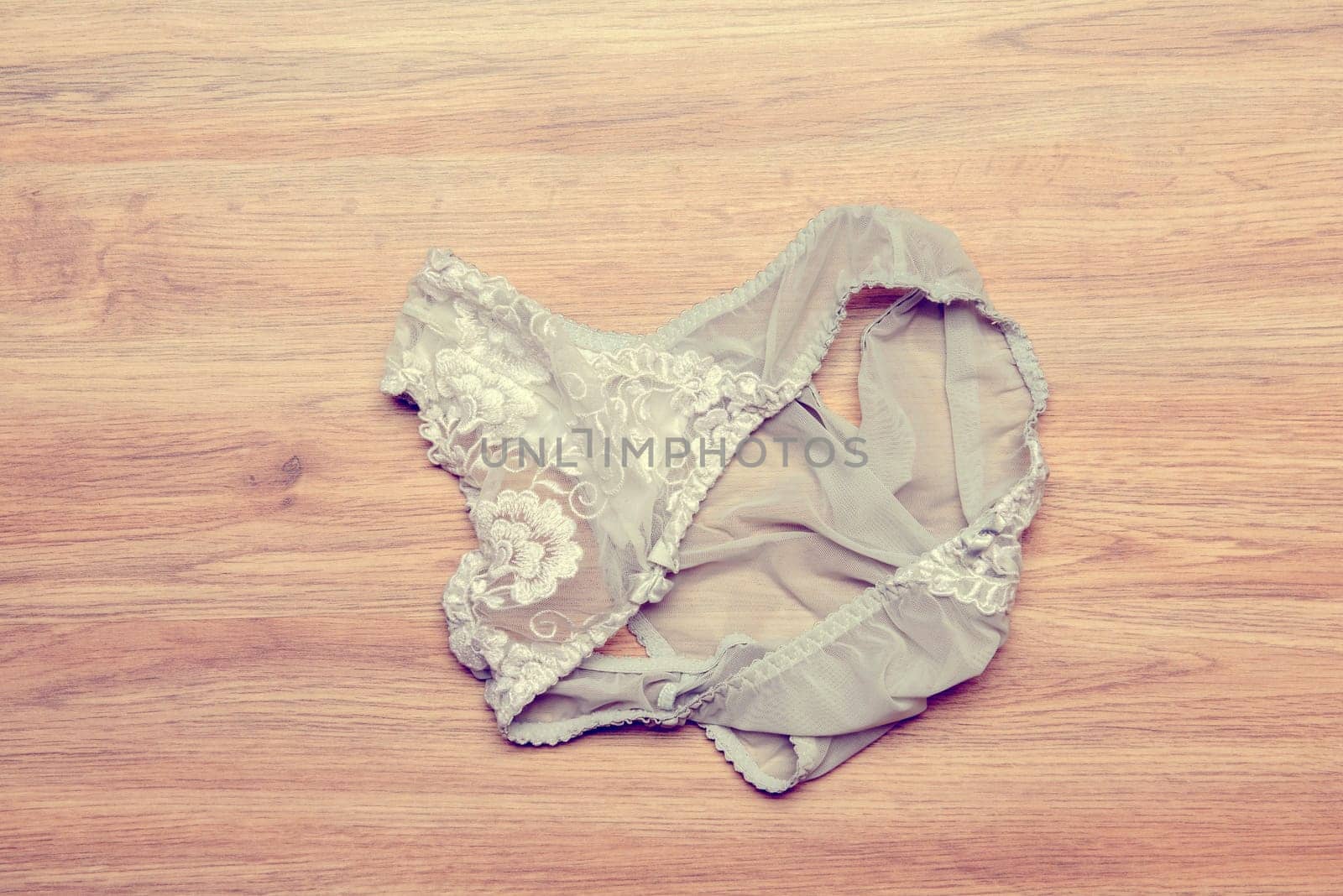 womans panties lying disheveled on wooden floor