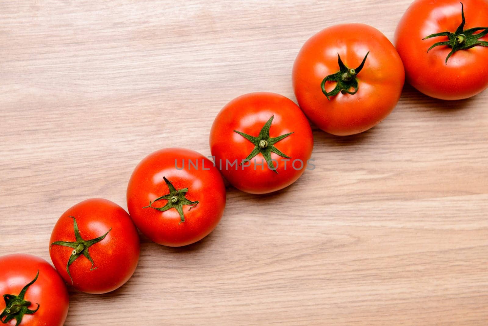 red tomatoes on wooden ground from above