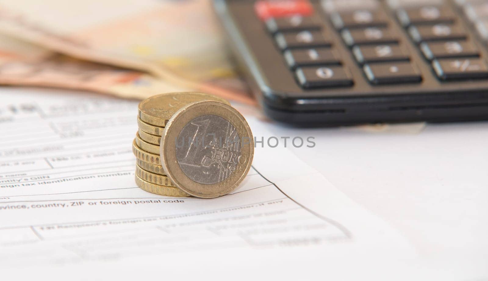 close up of euro currency. coins,banknotes and calculator
