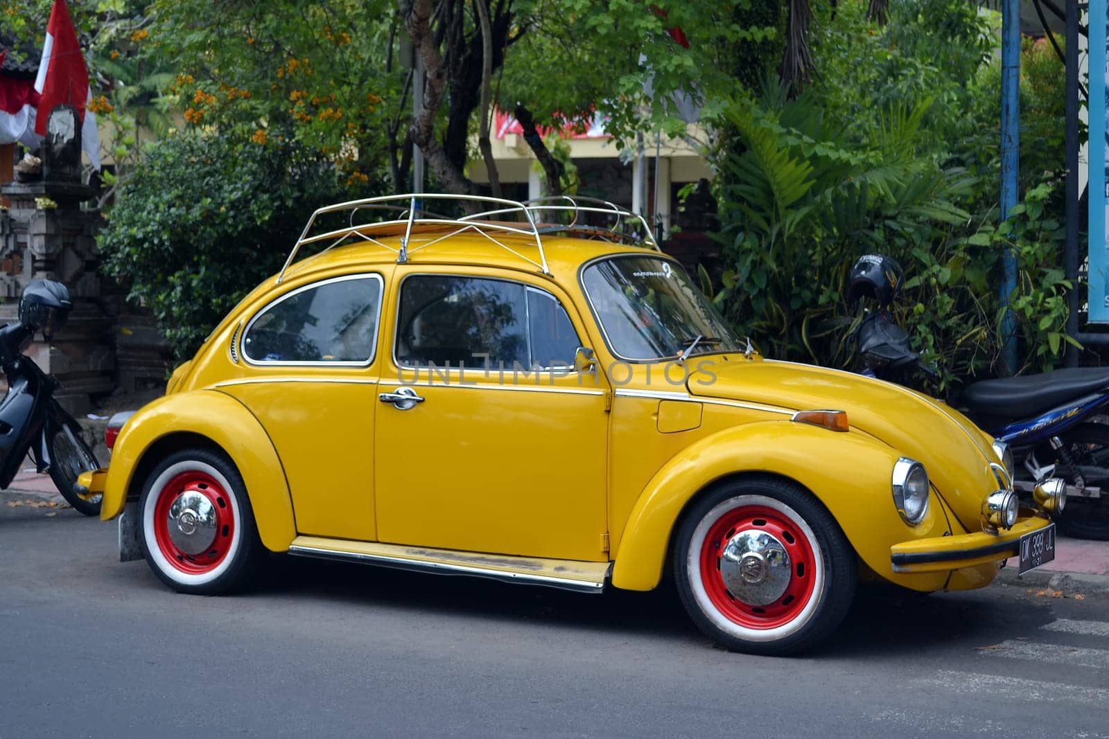 Ubud, Bali - August 28, 2016: Vintage Yellow Volkswagen Beetle Parked on a Street in Ubud, Bali