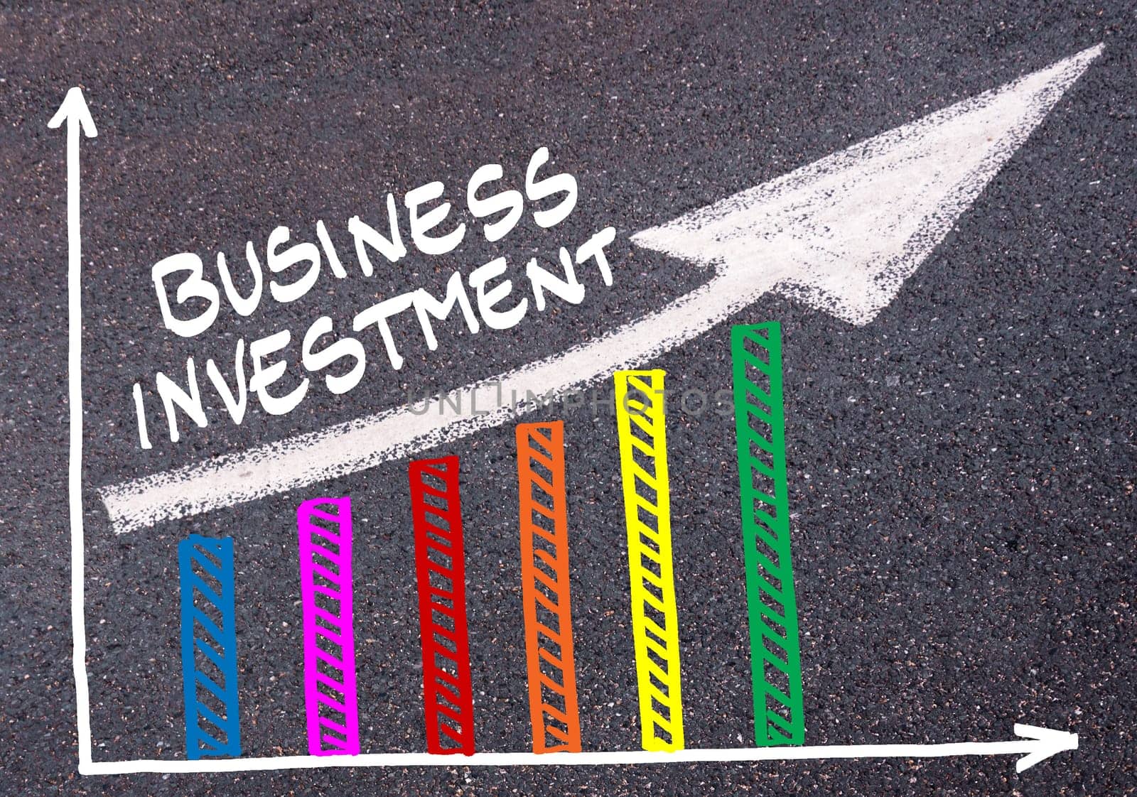 Colorful graph drawn over tarmac and words BUSINESS INVESTMENT with directional arrow, business design concept