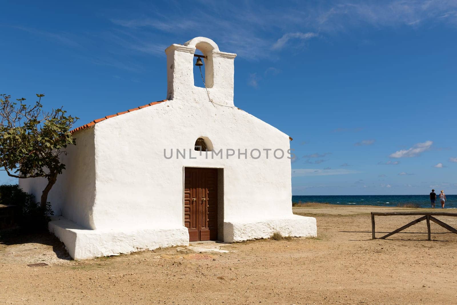 Posada, Italy - September 08, 2016: Posada - Church of Saint Lucia, Posada. North Sardinia. Small church with a single nave, the white facade with the entry portal which is surmounted by a large belfry.