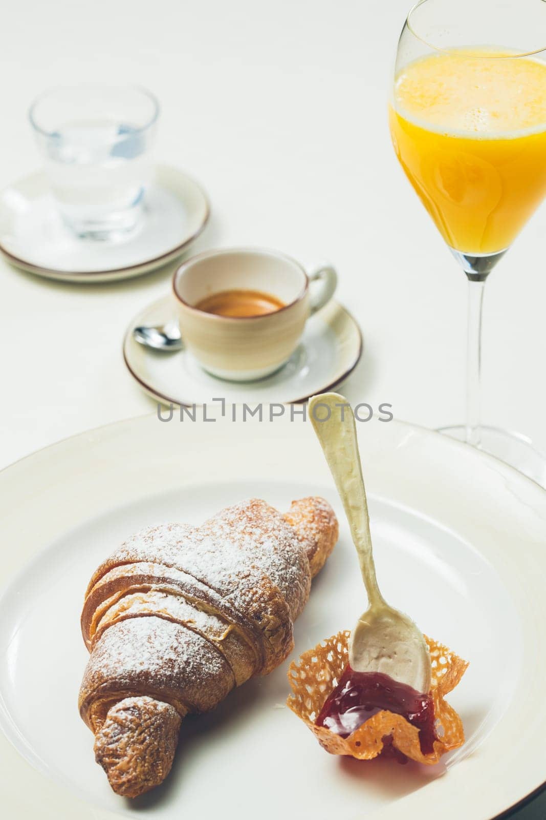 breakfast with croissant,coffee and juice. Warm colors. Shallow dof.