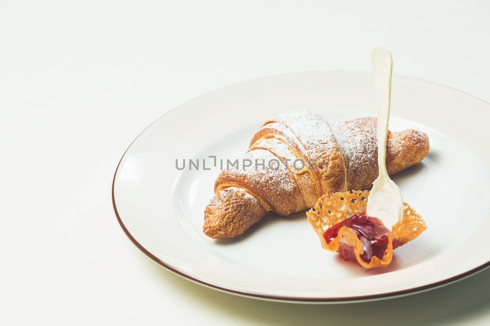 breakfast with croissant. Warm colors. Shallow dof.