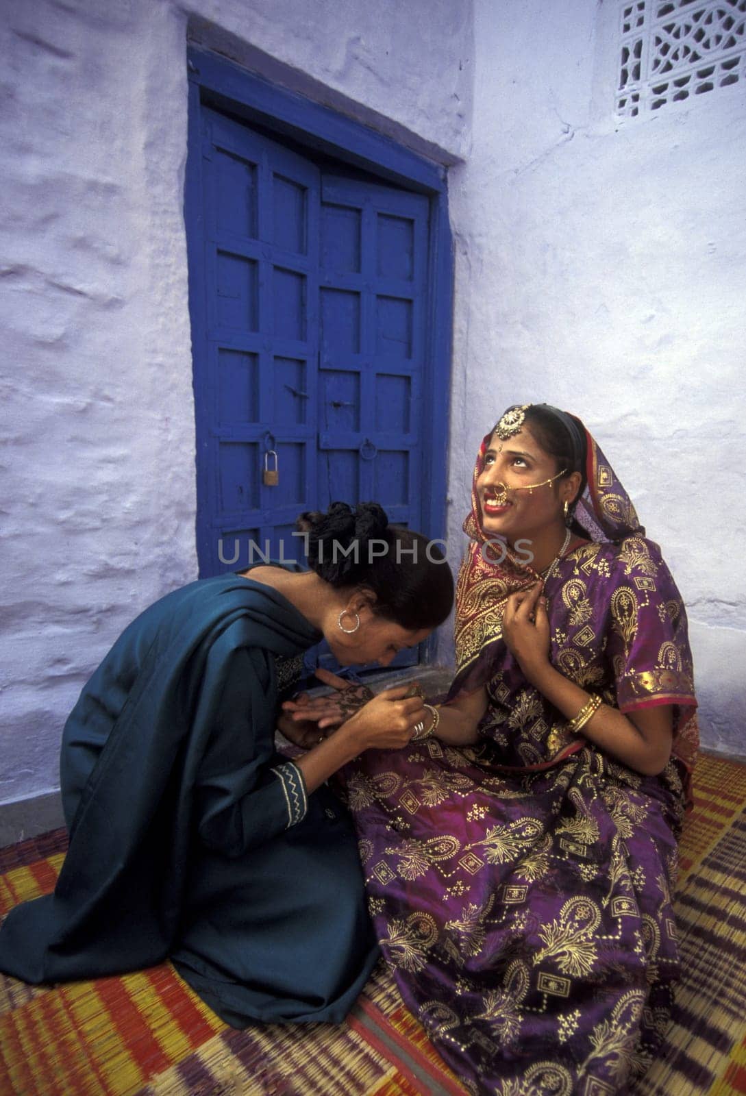 a woman is making henna in the town of Jaisalmer in the province of Rajasthan in India.