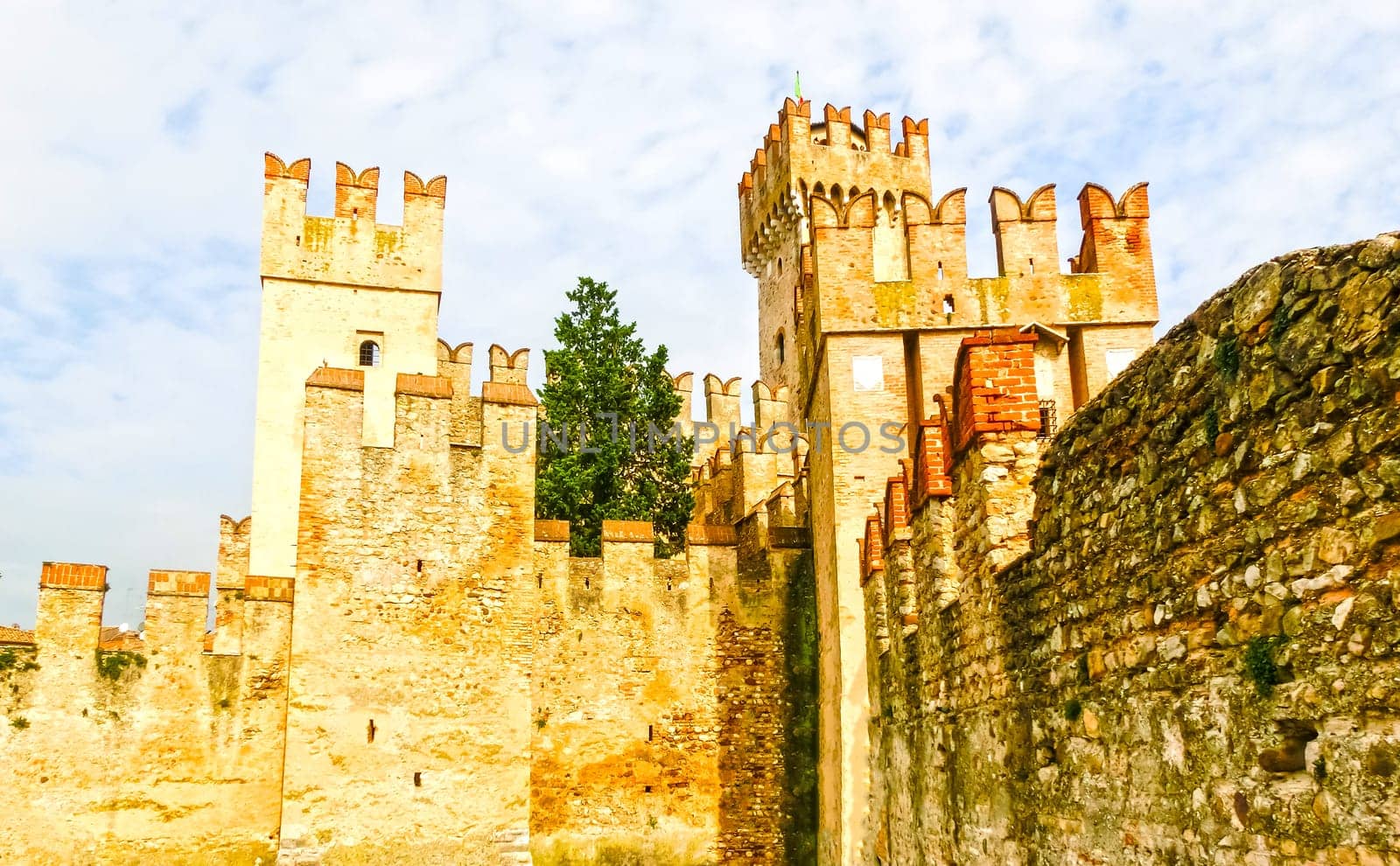 Sirmione, Italy - September 20, 2014: Scaliger Castle. The famous castle of Sirmione and its small port are an uncommon example of a fortress used as a port. The building of this complex started in 1277 by Mastino della Scala.