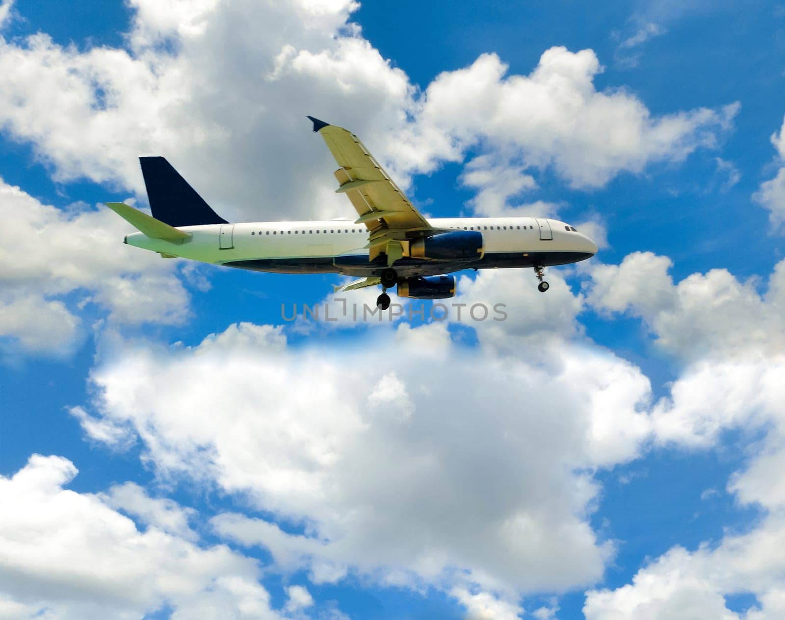 The airplane in the blue sky with clouds