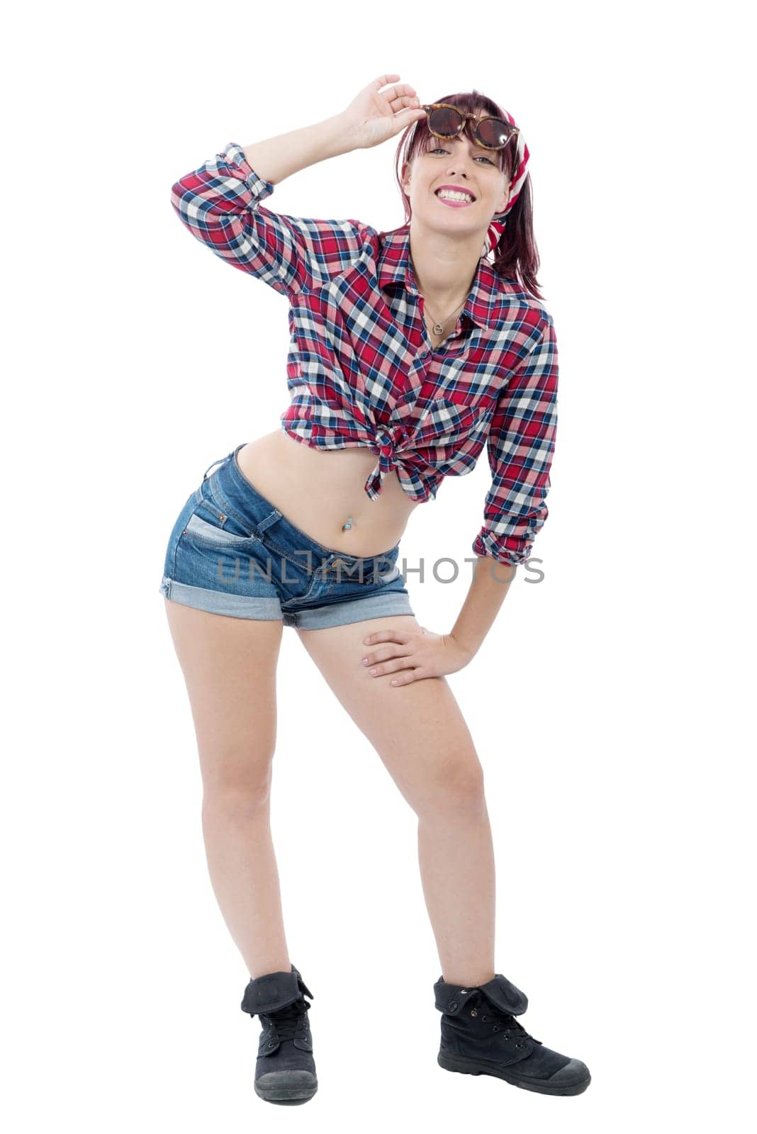 Full length of lovely pretty young woman in checkered shirt and jeans shorts standing