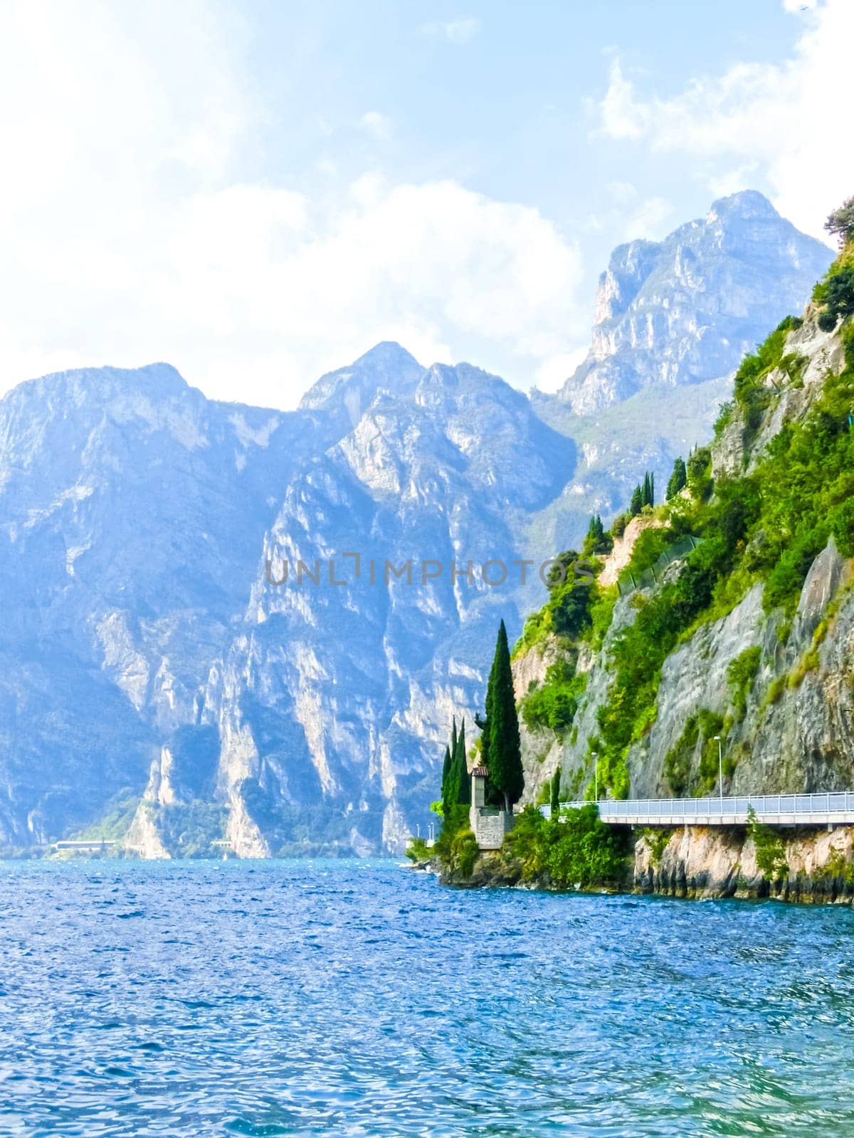 High mountains and walkway on the shore, Lake Garda, Italy, Europe