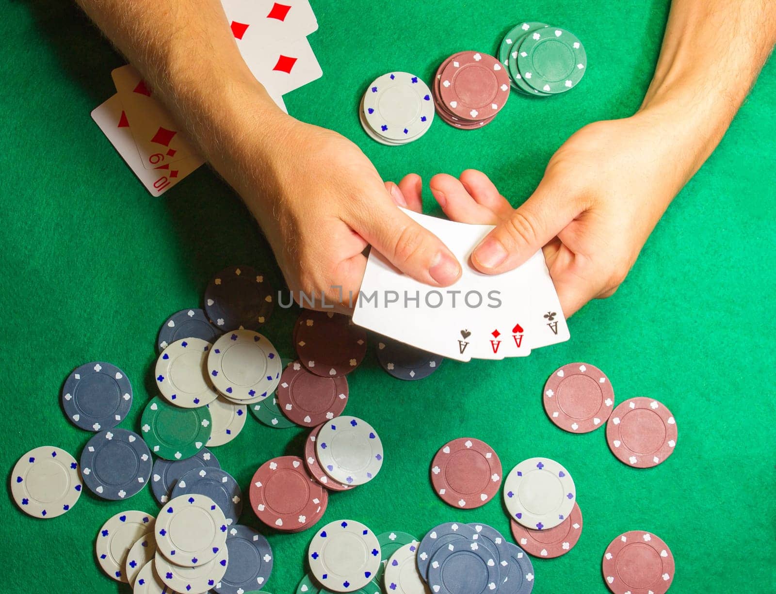 The male hands with cards in casino and chips