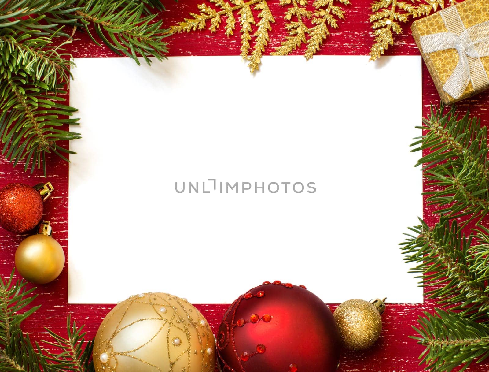 Christmas composition with decorations and paper on wood