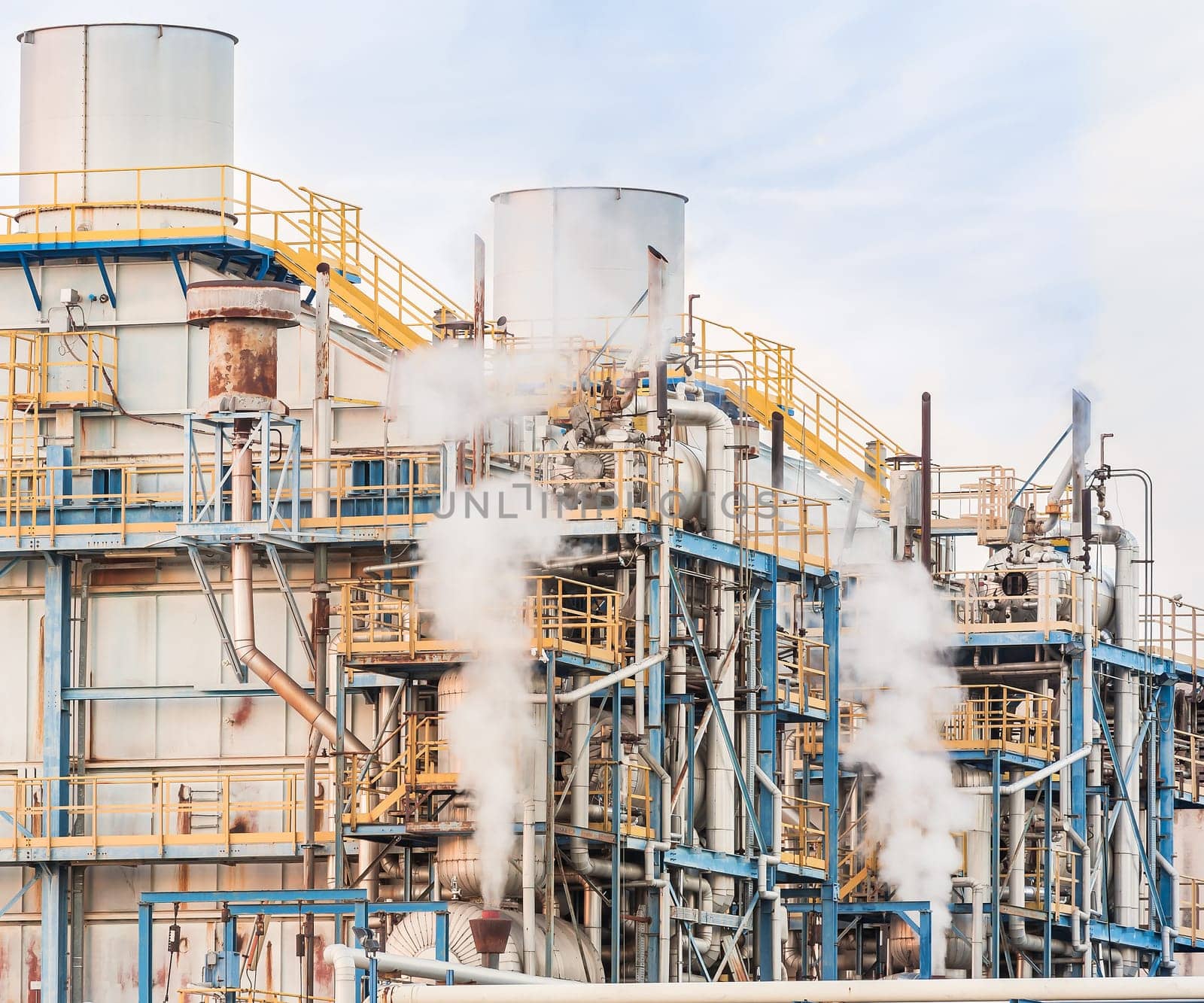 Chemical plant of a factory. Smokestacks ,pipes and tank.
