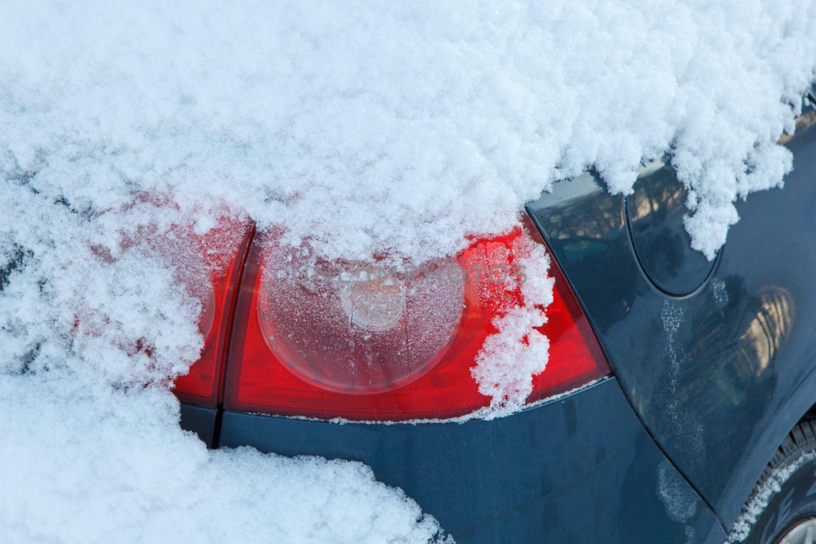The back light of a snow covered car