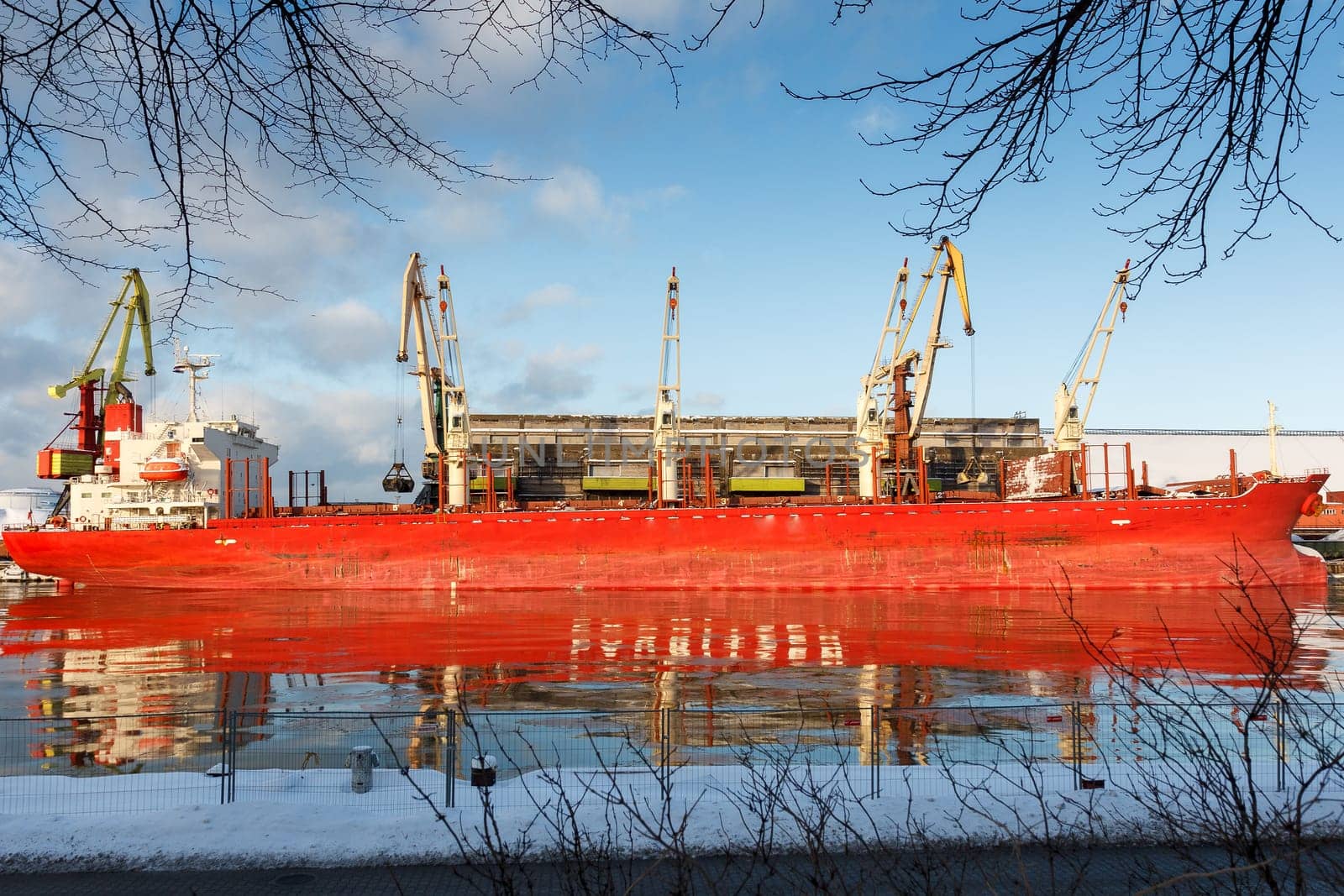 A big cargo ship reflecting on a river