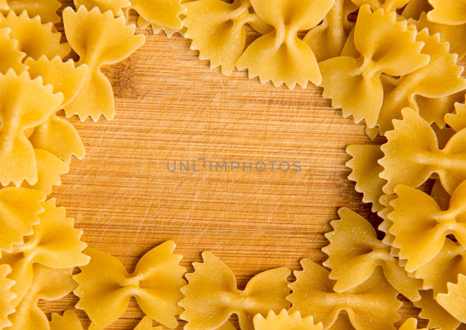 closeup of uncooked italian pasta frame - farfalle