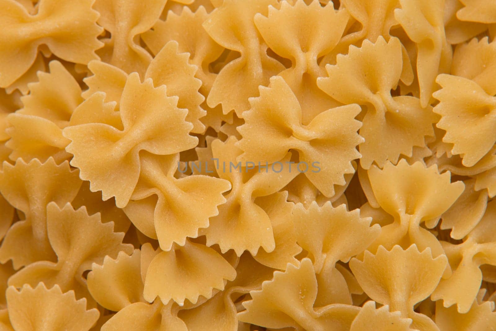 closeup of uncooked italian pasta - farfalle