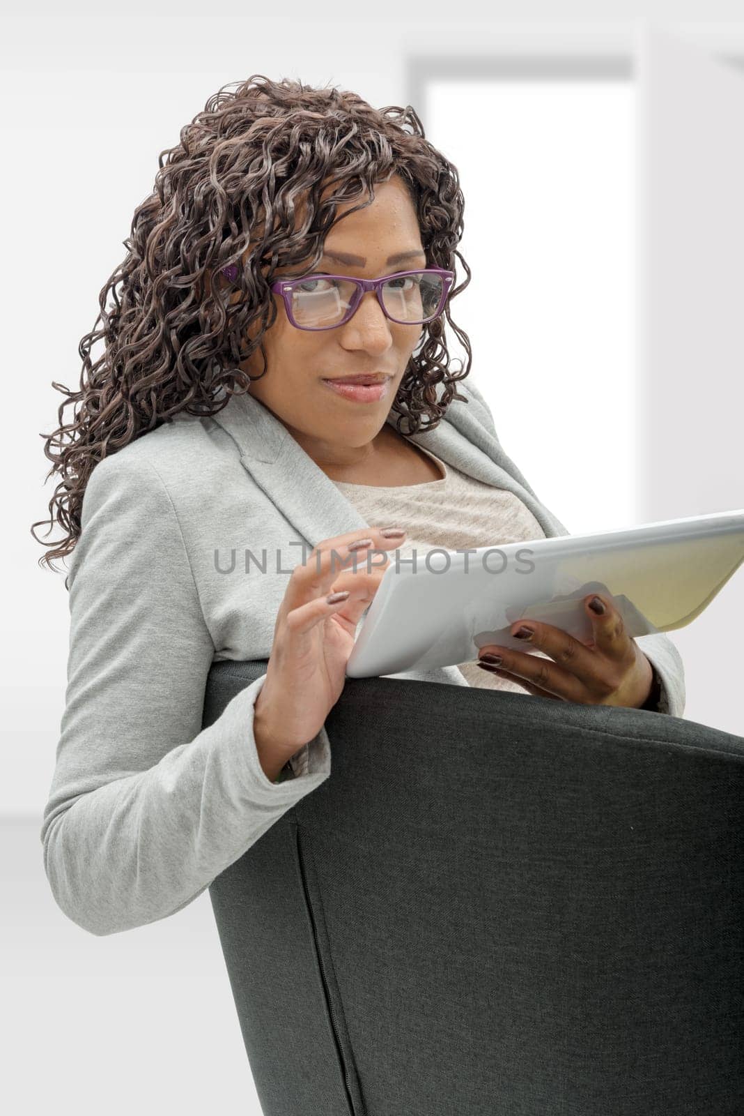 pretty young african american woman with eyeglasses and tablet computer