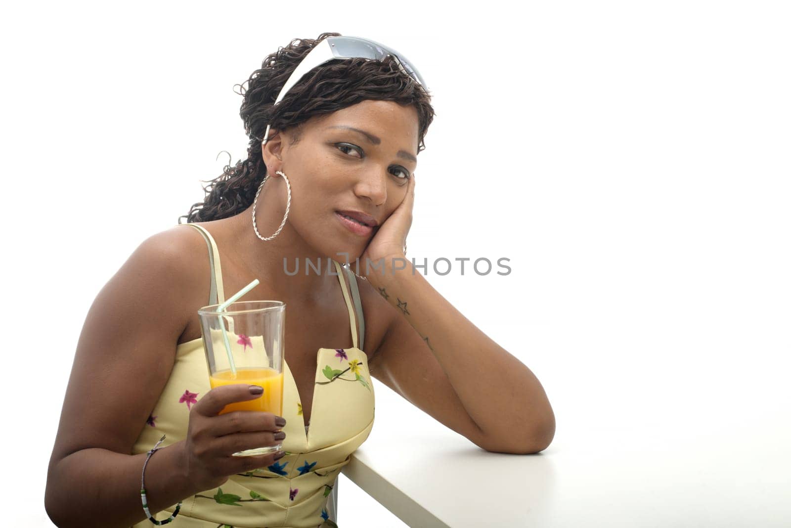 a beautiful African woman drinking orange juice