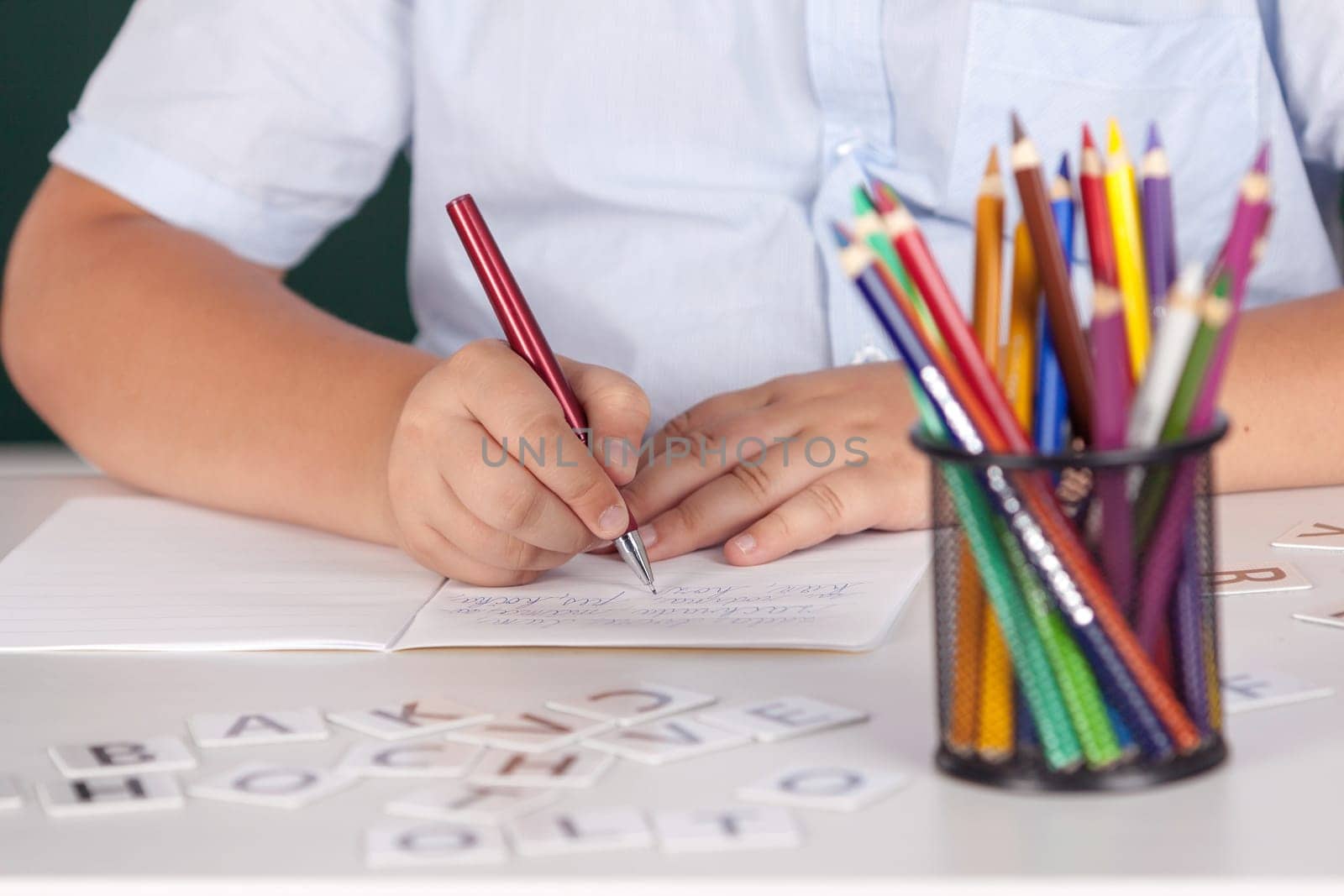 Young boy at school writing assignment