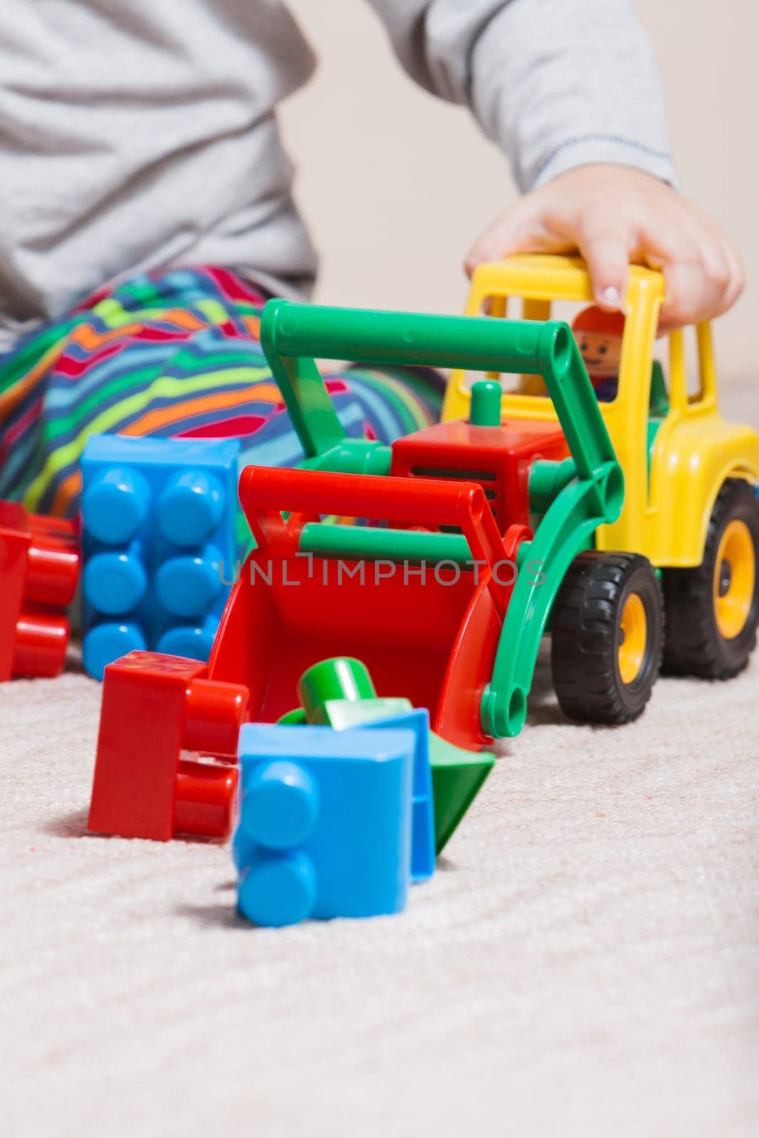 Playing little boy with colored cubes