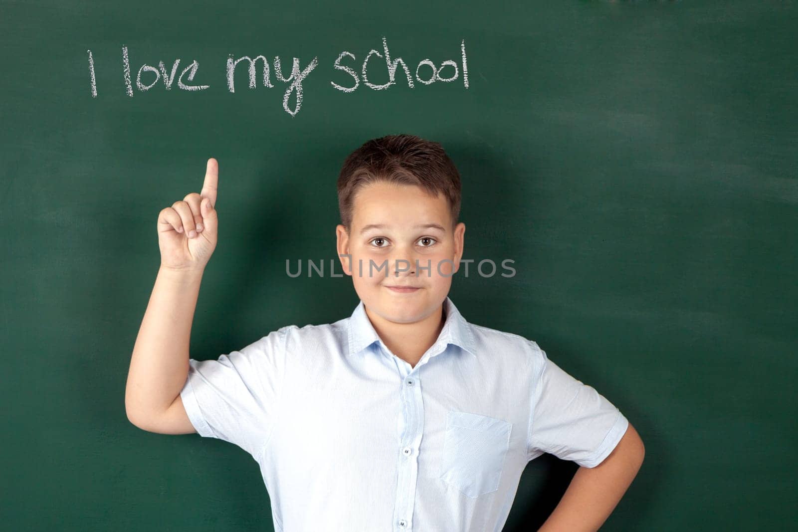 boy in a shirt with school boards with bulb and idea