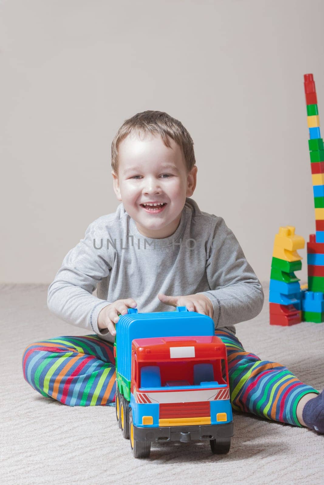Playing little boy with colored cubes