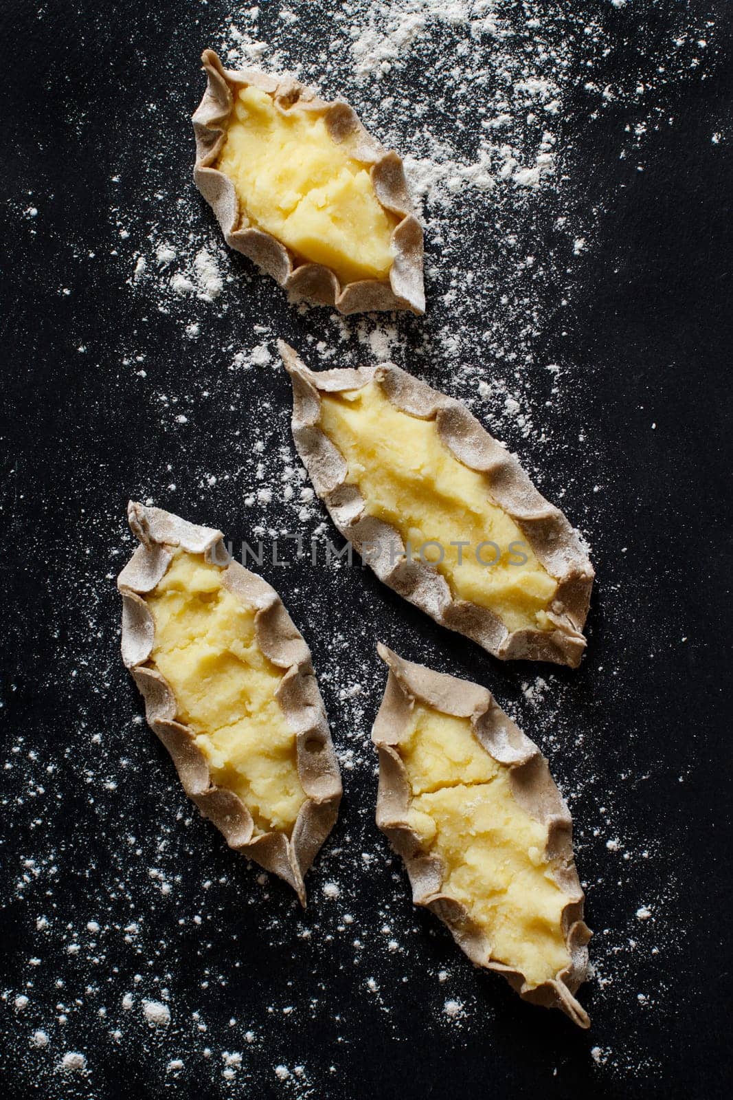 Traditional karelian pasties with potatoes before oven