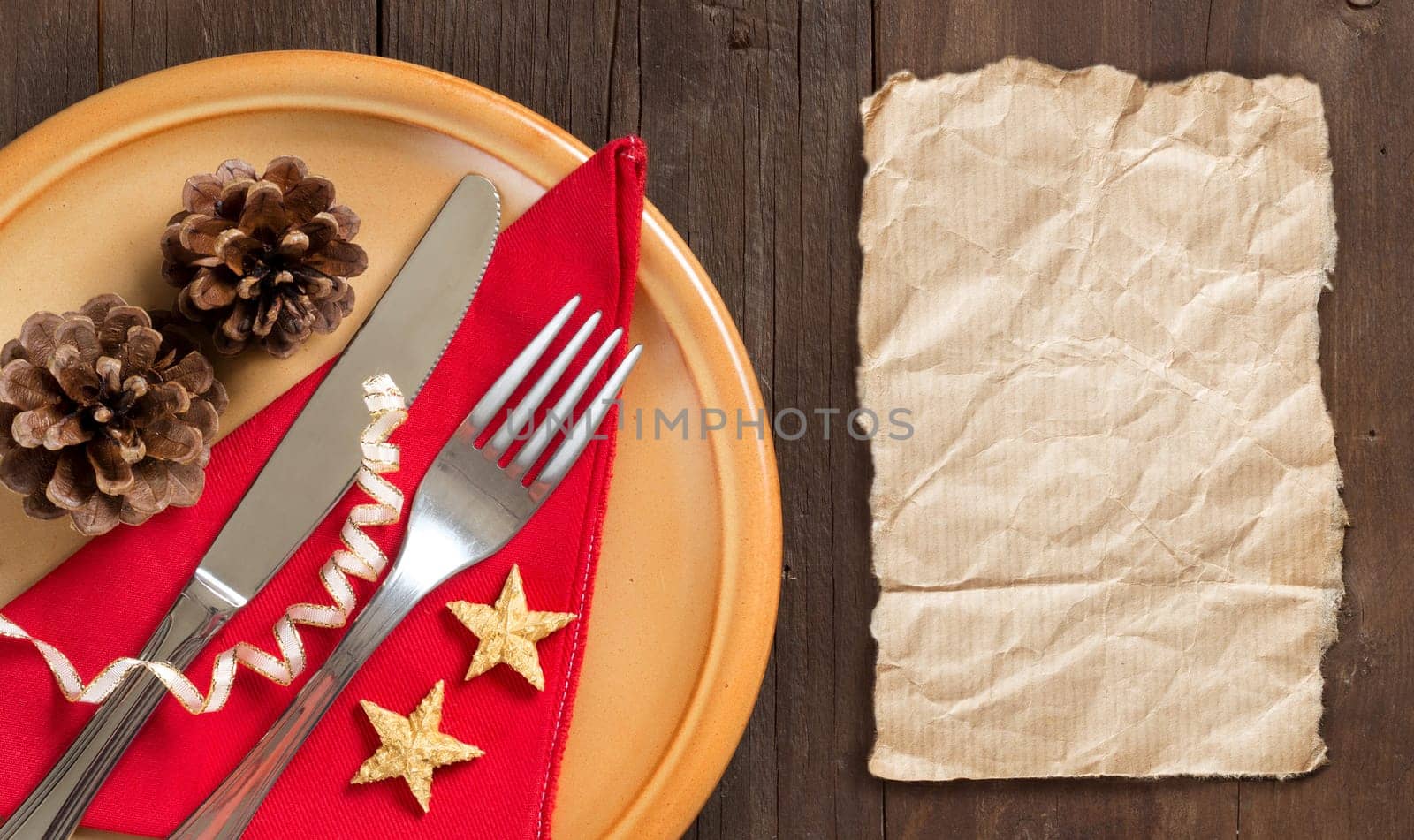 Festive table setting and craft paper on wooden table