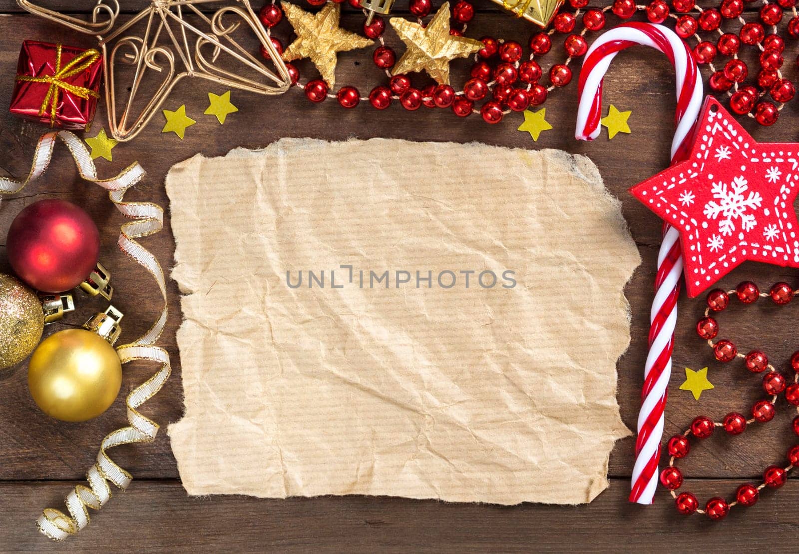 Christmas composition with decorations and paper on wood