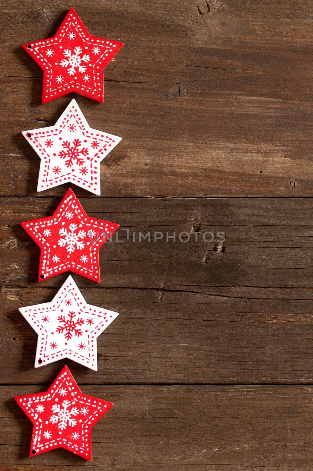 Christmas red and white stars on wooden background